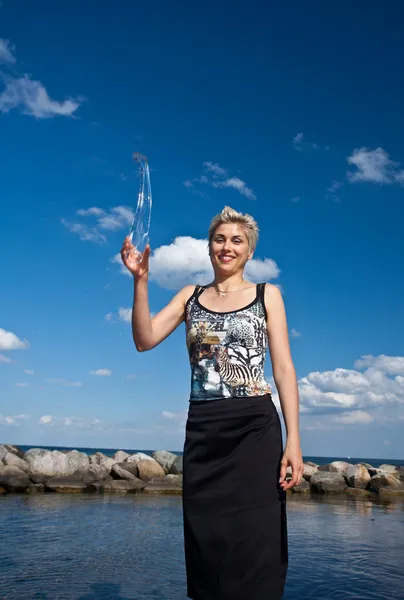 Cute blond girl playing with water — Stock Photo, Image