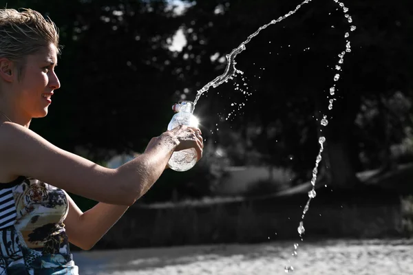 Cute blond girl playing with water — Stock Photo, Image