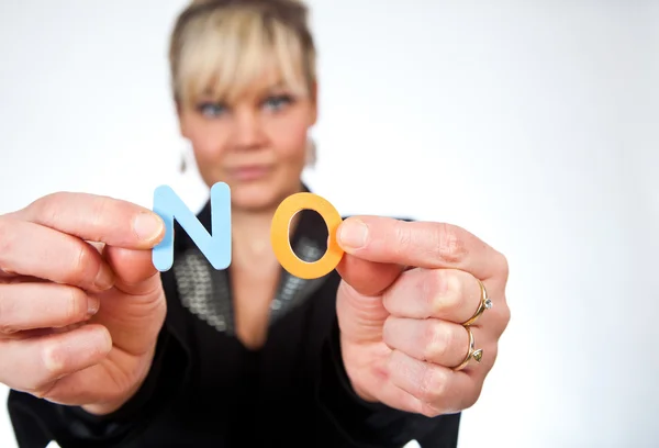 Studio portrait of a cute blond girl holding two letters forming — Stock Photo, Image