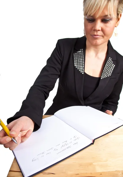 Studio portrait of a cute blond girl writing — Stock Photo, Image