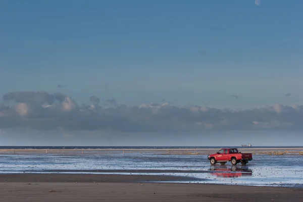 Carro vermelho na praia Ilha de Fanoe na Dinamarca — Fotografia de Stock