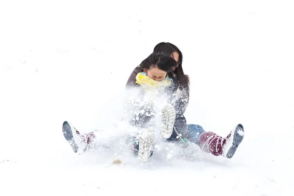 Two sisters sledging holding each other — Stock Photo, Image