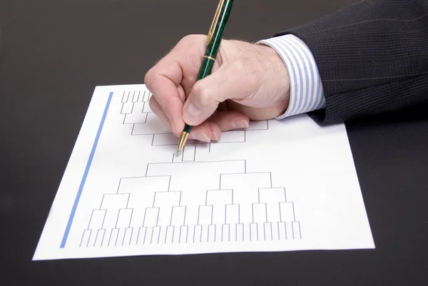 March Madness Businessman Hand Filling In Brackets Stock Photo