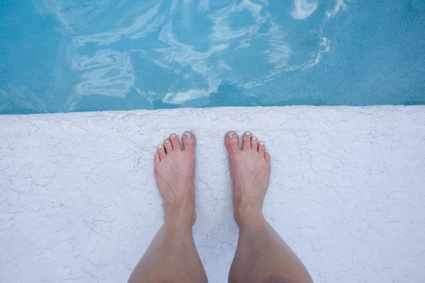 Feet at the edge of the pool — Stock Photo, Image