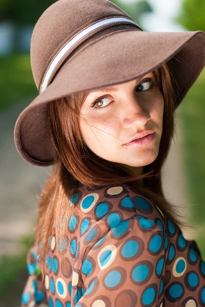 Güzel bir genç kadın giyiyor şapka — Stok fotoğraf