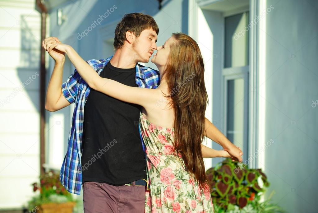 Young happy couple dancing outdoors