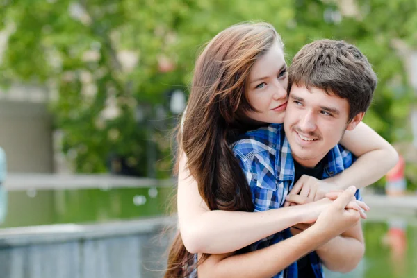 Молодая счастливая улыбающаяся пара обнимает — стоковое фото