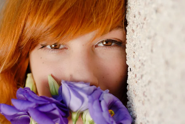 Young beautiful woman smelling purple chinese rose head shot — Stock Photo, Image