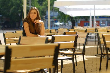 açık teras kafe masada oturan genç güzel kadın