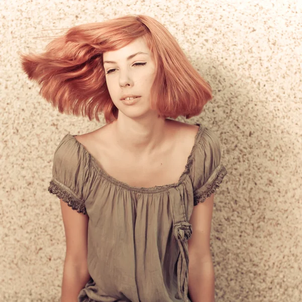 Young beautiful redhaired teenage girl playing with hair — Stock Photo, Image