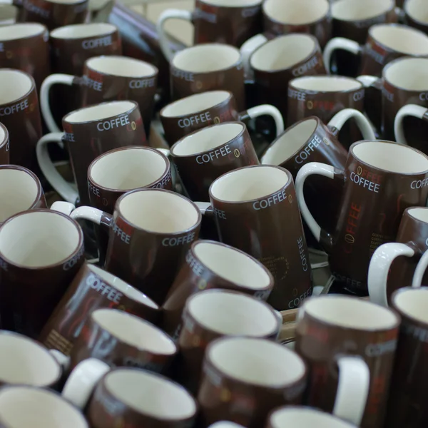 Molte tazze di caffè marroni in una linea in vendita — Foto Stock