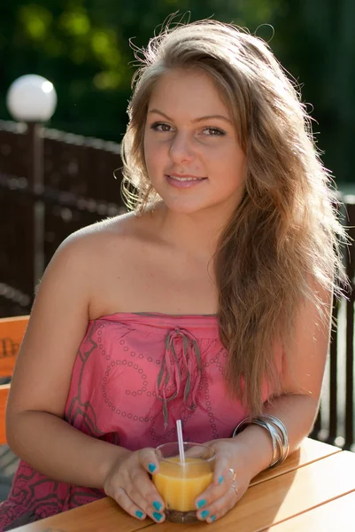 Young woman with orange juice — Stok fotoğraf