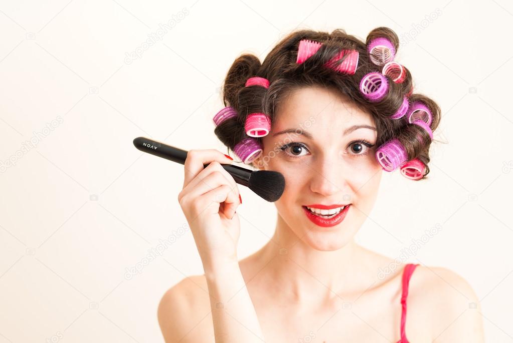 Woman putting makeup getting ready for fun