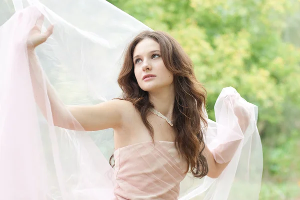 Beautiful young sensual woman with white silk scarf — Stock Photo, Image