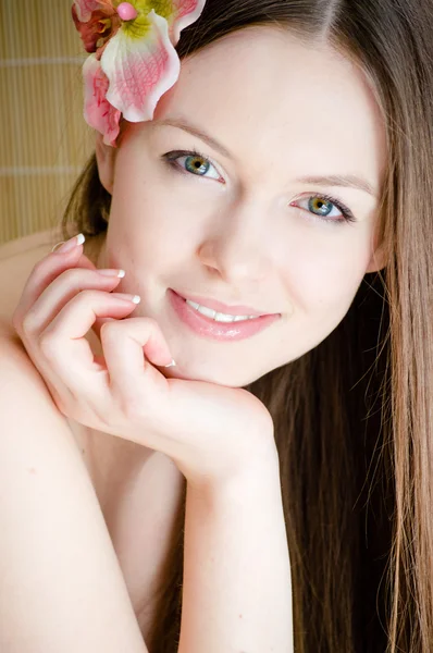Beautiful lady face & flower. Perfect skin. Stock Photo