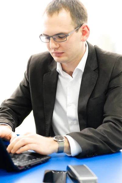 Businessman using laptop in office. — Stock Photo, Image