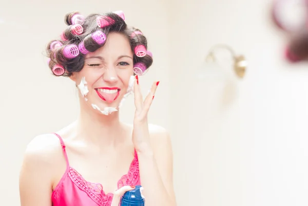 Beautiful funny girl applying shaving foam to her face — Stock Photo, Image
