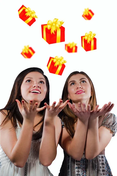 Two happy teen girls catching presents — Stock Photo, Image