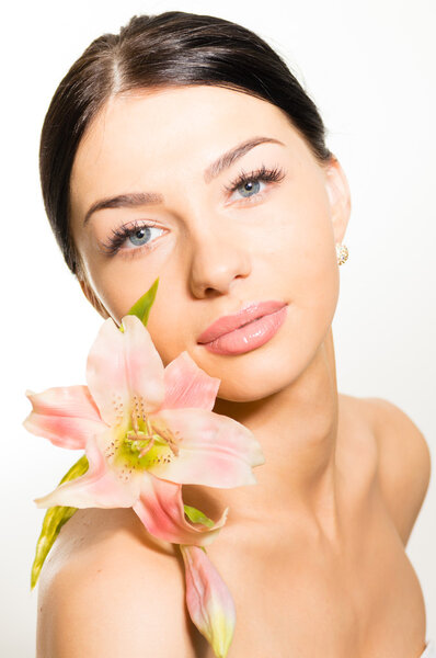 Closeup on beautiful girl face & pink flowers, perfect skin & lips on white space