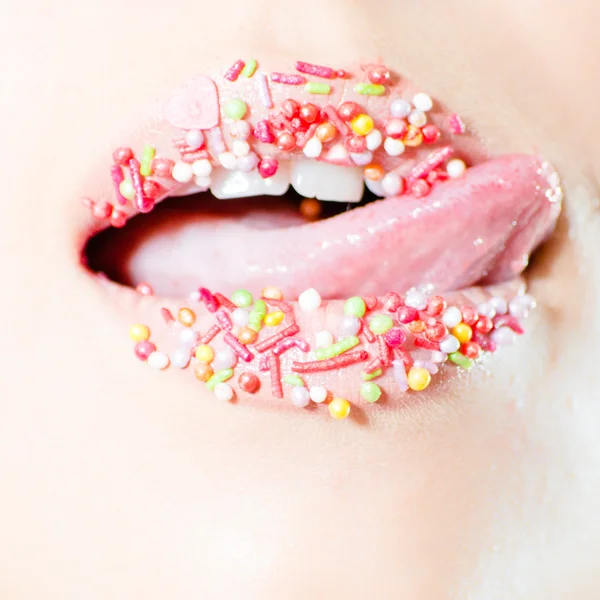 Closeup on female sweet candy lips with licking tongue — Stock Photo, Image