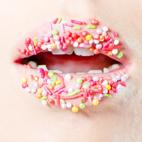 Closeup on female sweet candy lips with licking tongue — Stock Photo, Image