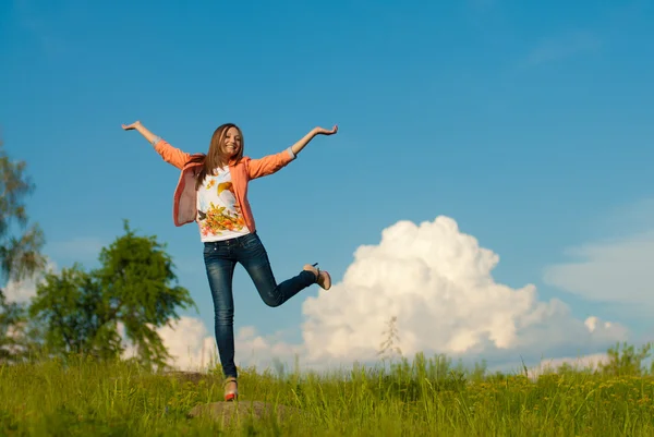 Happy teenage girl jumping on the summer outdoors background — Stock Photo, Image
