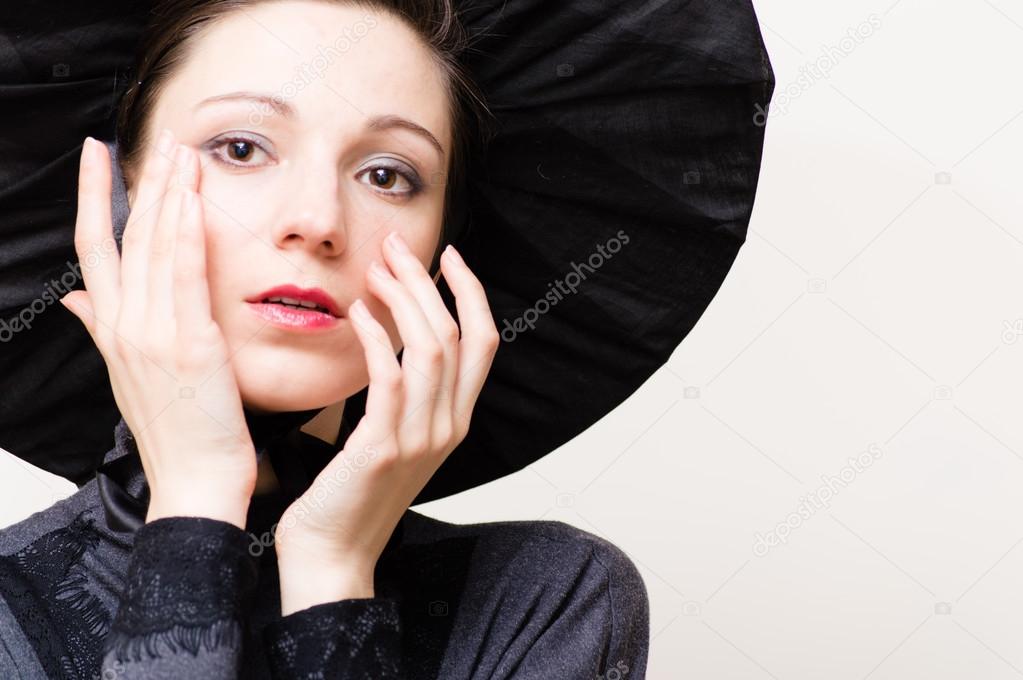 Young woman in vintage cloth wiping tears