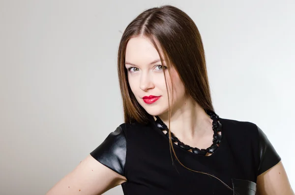 Portrait of a beautiful happy smiling young woman in black dress — Stock Photo, Image