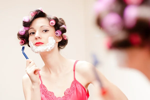 Beautiful funny girl shaving with foam & razor her face — Stock Photo, Image