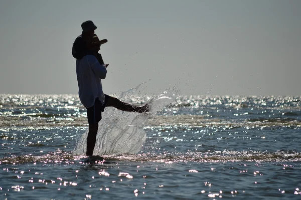 Feliz pai e filho na praia da praia se divertindo respingo de água — Fotografia de Stock