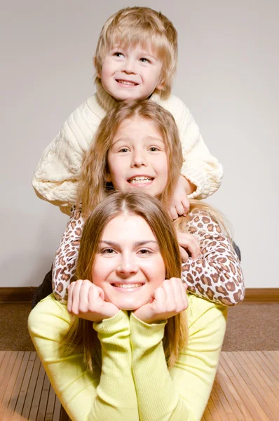 Three happy brother and sisters hug — Stock Photo, Image