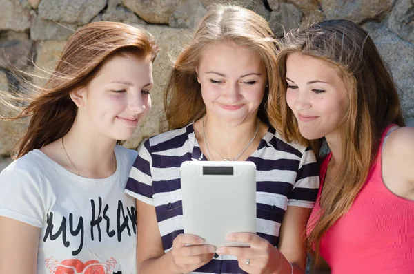 Happy teen girls and tablet computer Royalty Free Stock Images