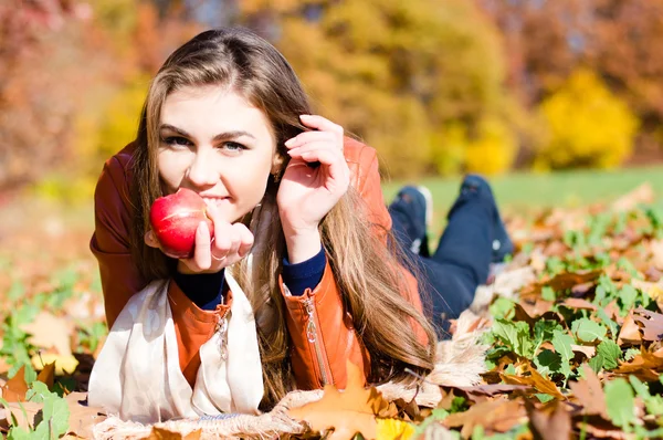 Beautiful young woman eating fresh red apple — Stock Photo, Image
