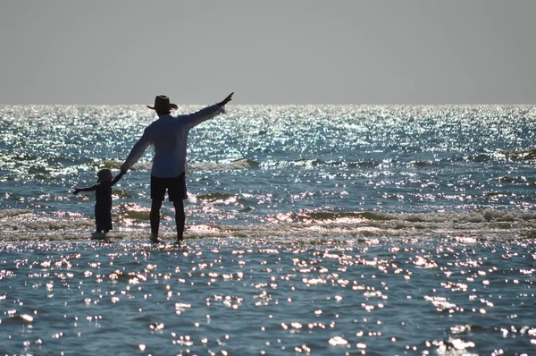 Feliz pai e filho na praia da praia se divertindo respingo de água — Fotografia de Stock