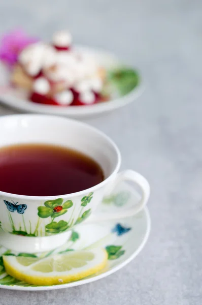 Sweet cake with cup of tea on wooden table — Stock Photo, Image