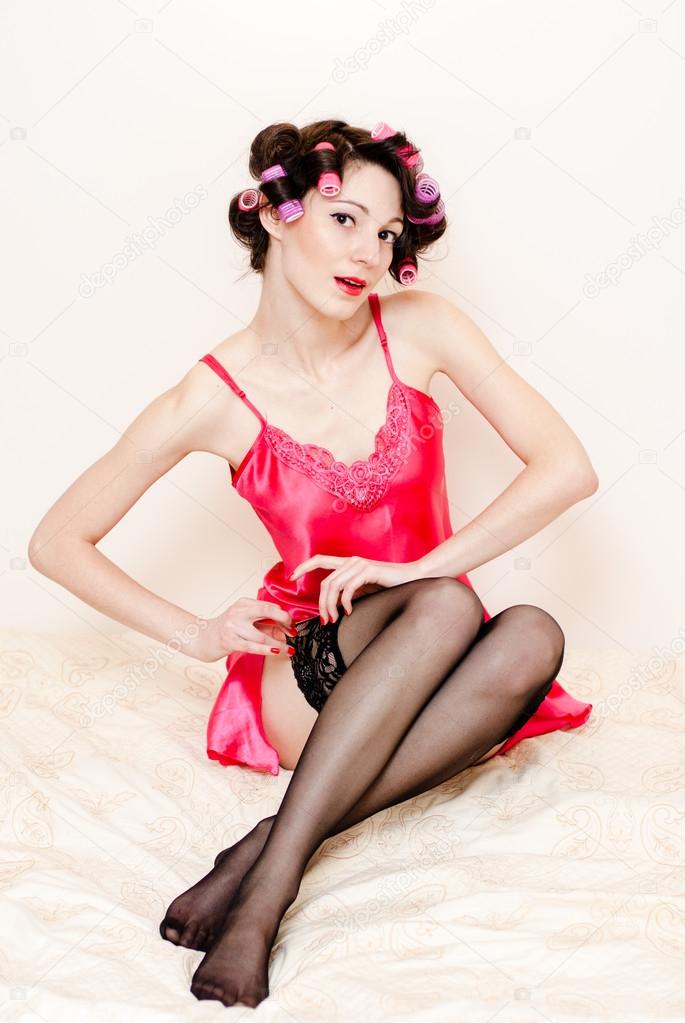 Young happy sexy pinup woman wearing pink dress and stockings Stock Photo by ©rosipro 39042473