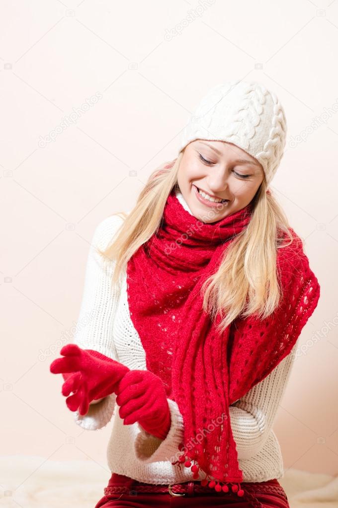 Pretty happy woman wearing red knitted scarf and gloves
