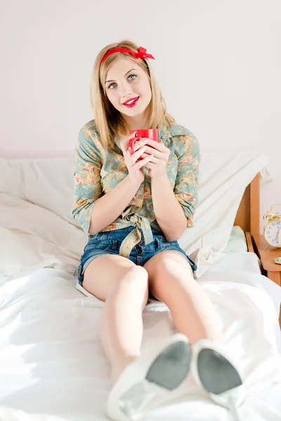 Girl holding cup of hot drink — Stock Photo, Image