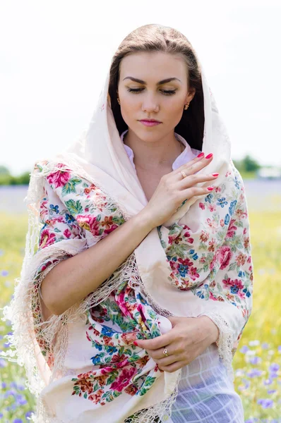 Woman  in the field holding a white shawl — Stock Photo, Image