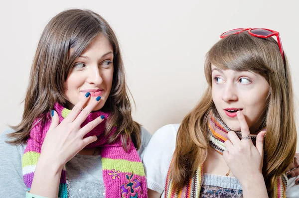 Girl friends having fun wearing knitted scarf — Stock Photo, Image