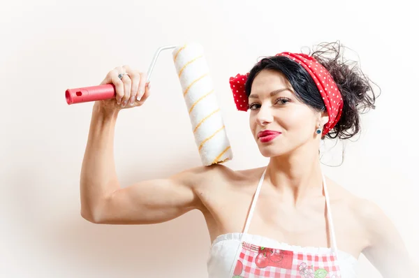 Attractive young brunette pinup woman with blue eyes holding bolster happy smiling & looking at camera — Stock Photo, Image