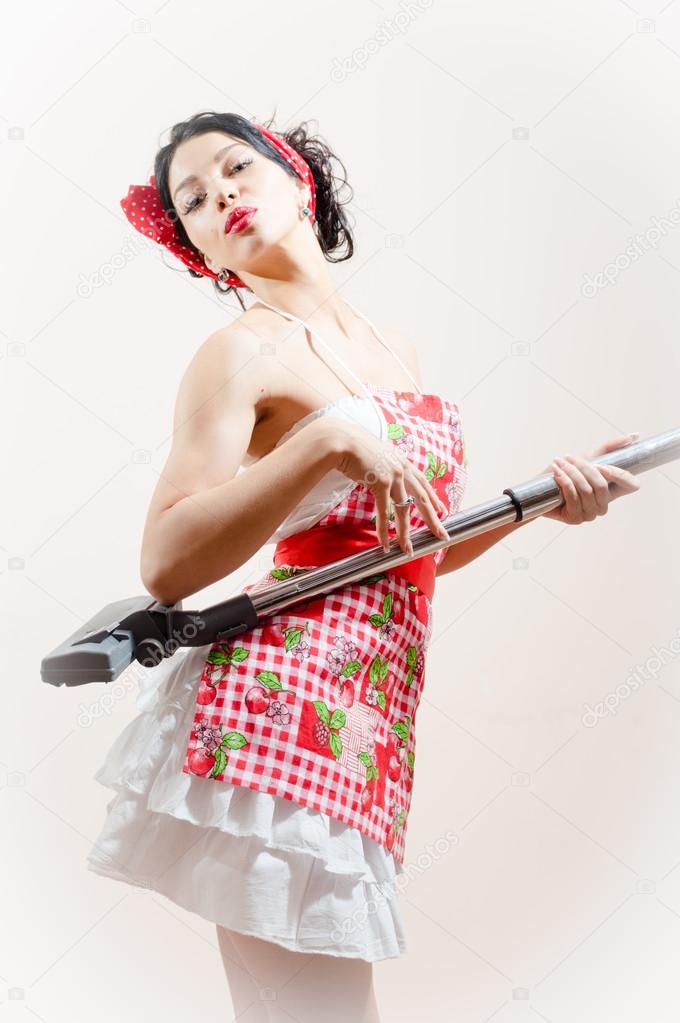 beautiful funny young brunette pinup woman embracing vacuum cleaner
