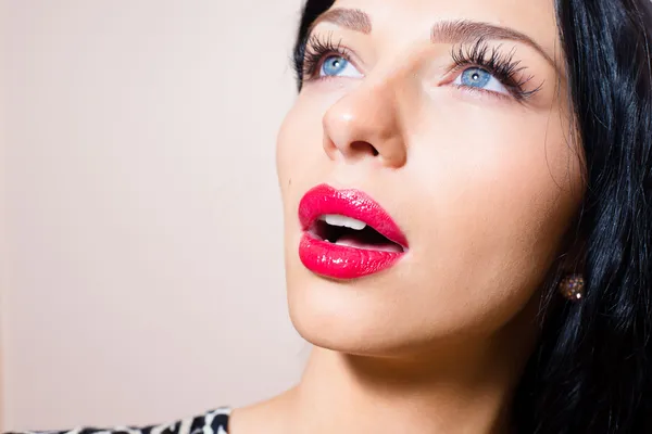 Closeup portrait of beautiful tempting brunette young sexy woman with blue eyes, long lashes, red lipstick looking up — Stock Photo, Image