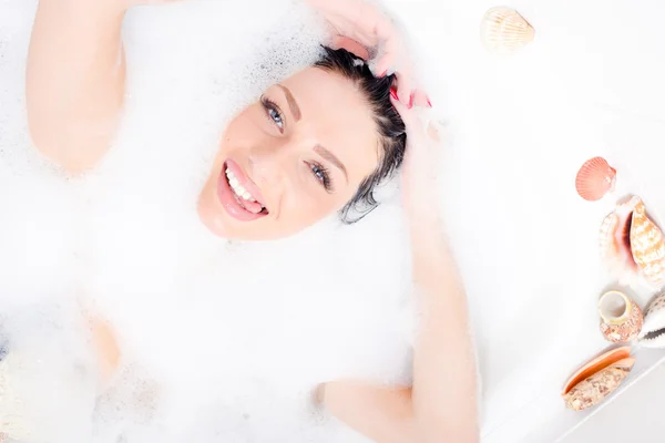 Sexy woman plunged into the foam — Stock Photo, Image