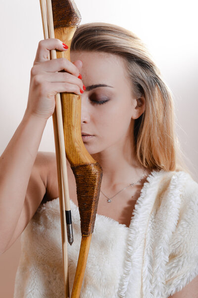 Beautiful girl holding arrow