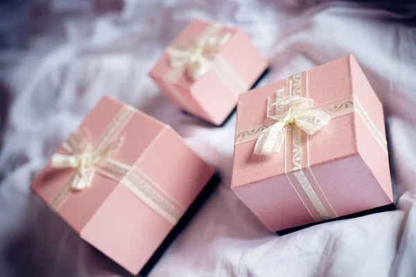 Presents with white ribbon — Stock Photo, Image