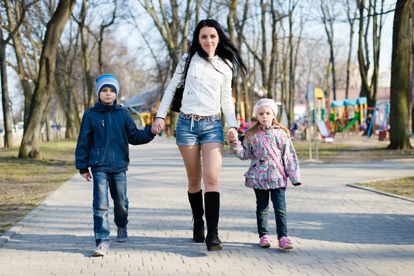 Mom walking with her son and daughter — Stock Photo, Image