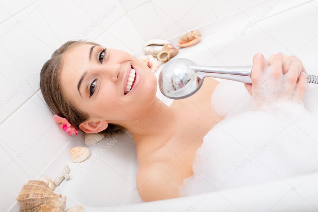 Woman in the bath  singing with shower