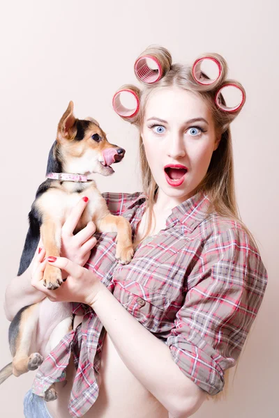 Surprised blonde holding a dog — Stock Photo, Image