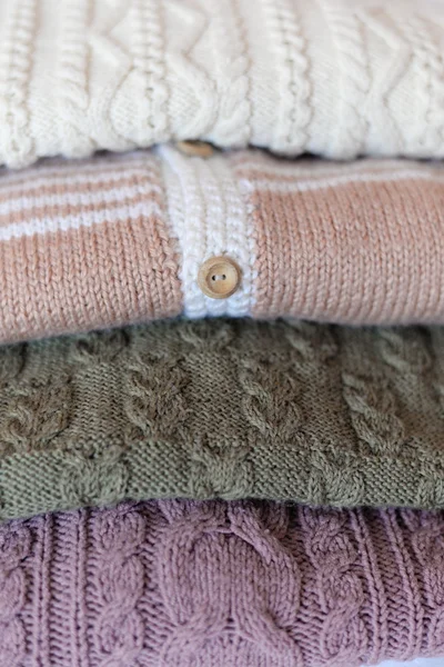 Picture of closeup on four wool sweaters in the column — Stock Photo, Image